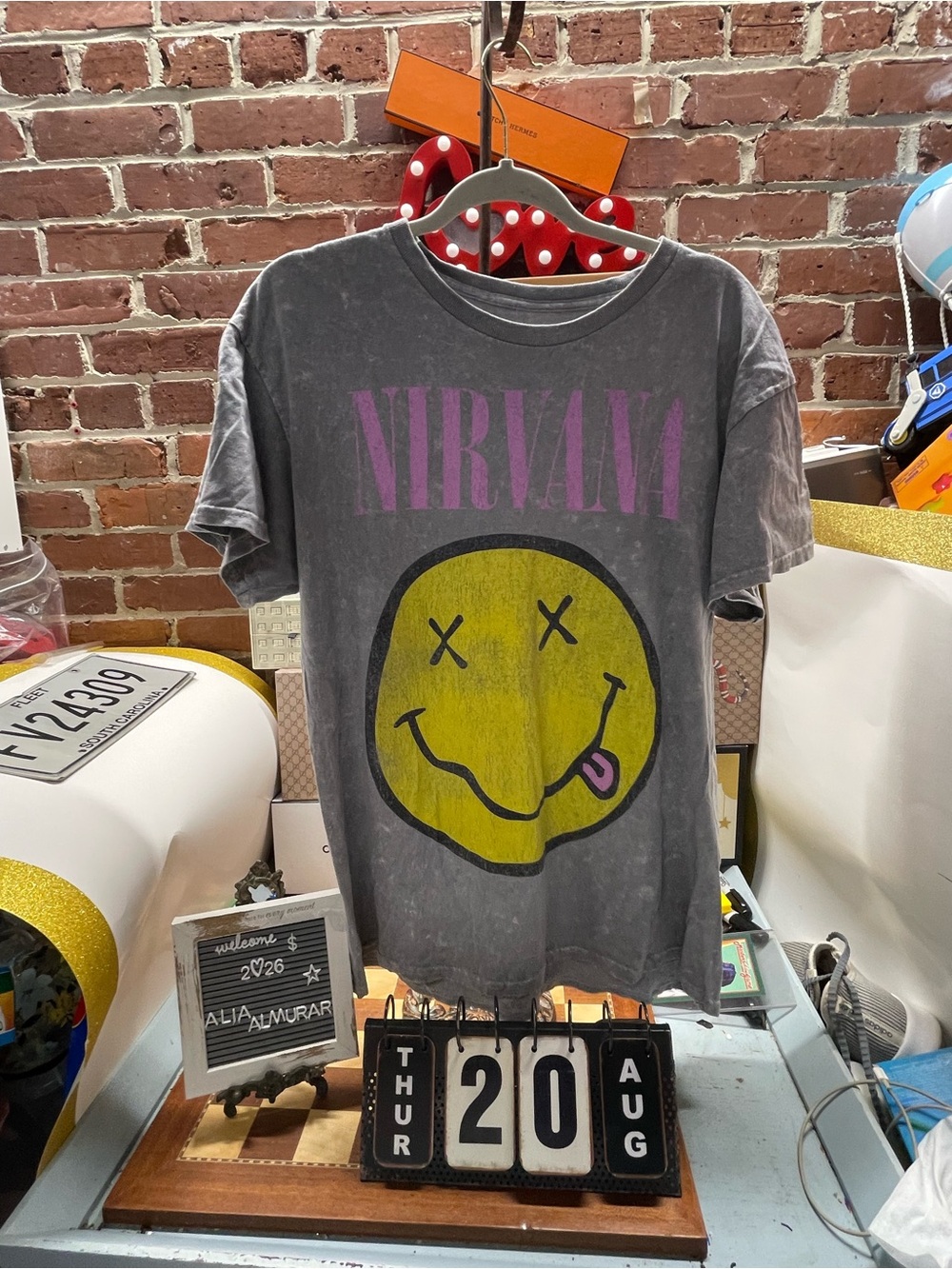 gray mineral-washed Nirvana graphic tee features the band's